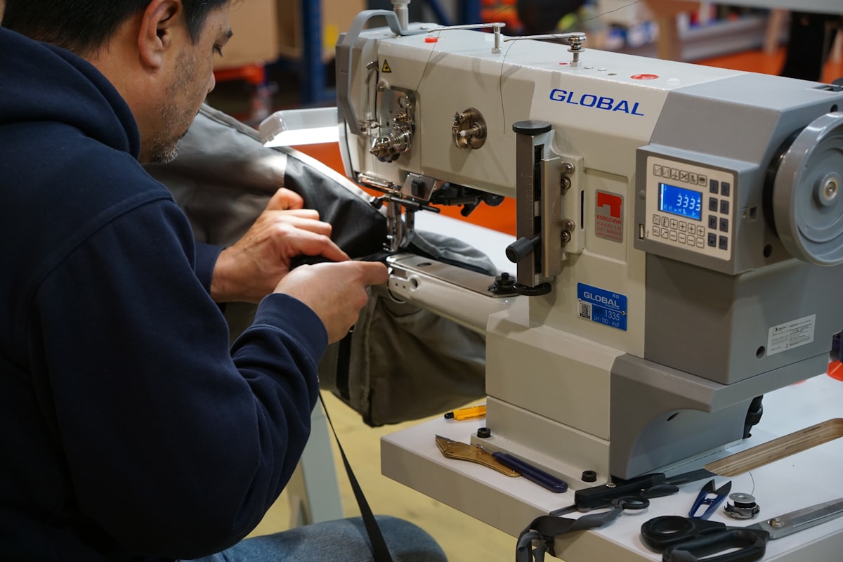 Operator stitching fabric on an industrial sewing machine